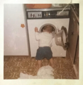 Small child invesitgating washing machine